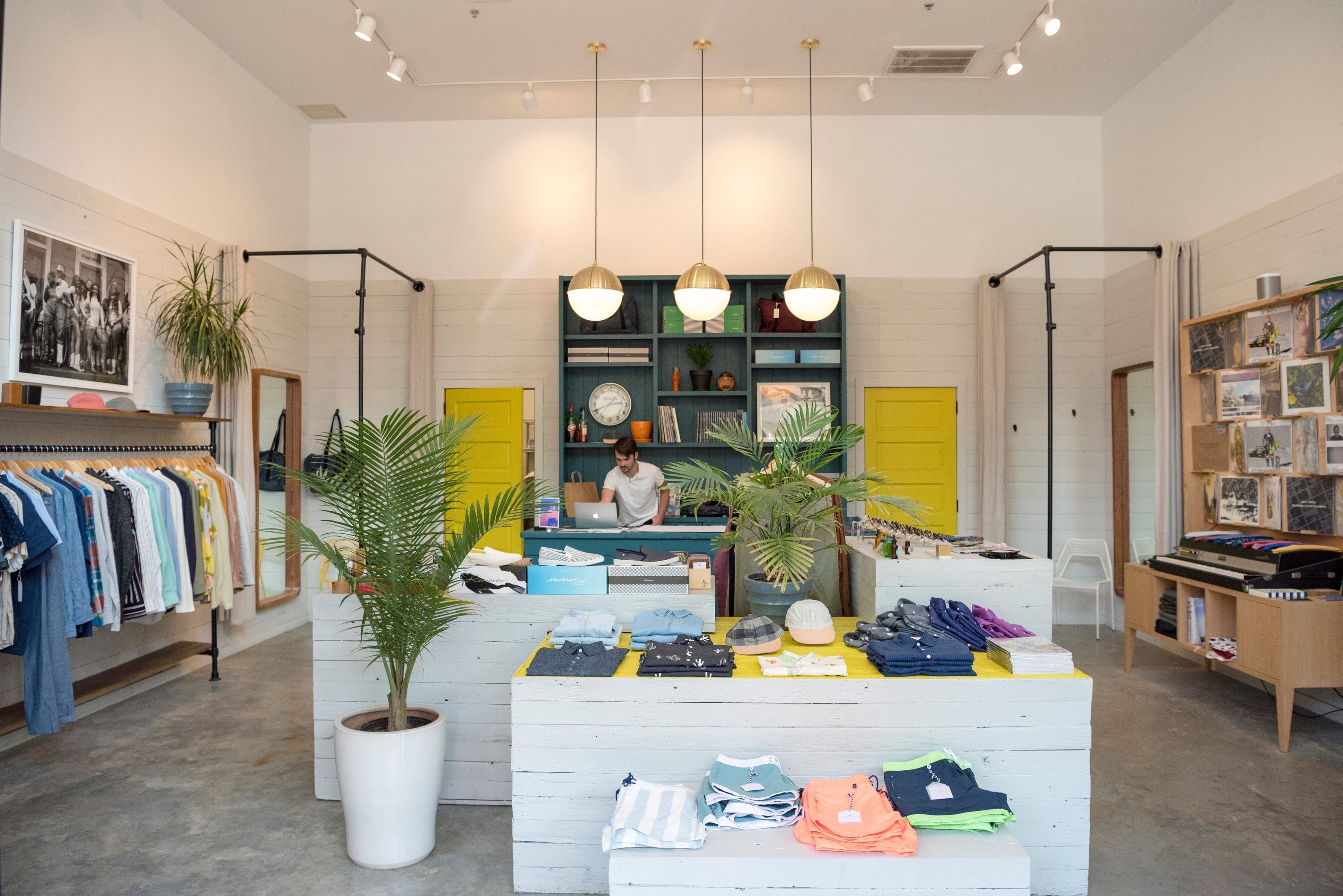 Retail store in New Orleans, Soma featuring clothing displayed neatly folded and hung on a rack.